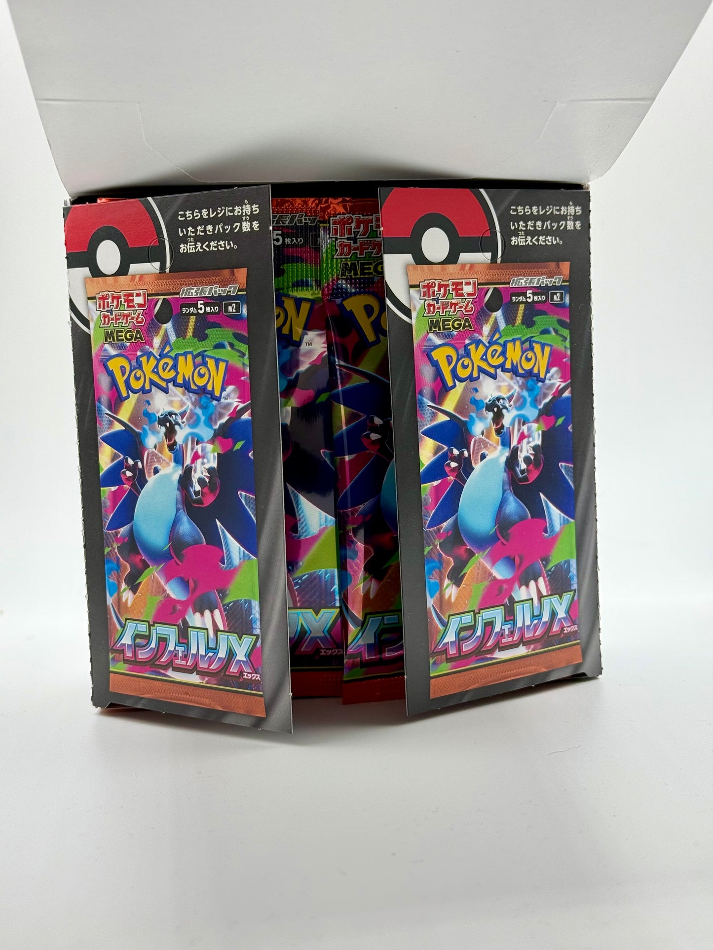 Eevolvd Mega Inferno Booster Box med 30 booster packs med fokus pa oppningen som visar korten direkt fran Pokemon Center Japan